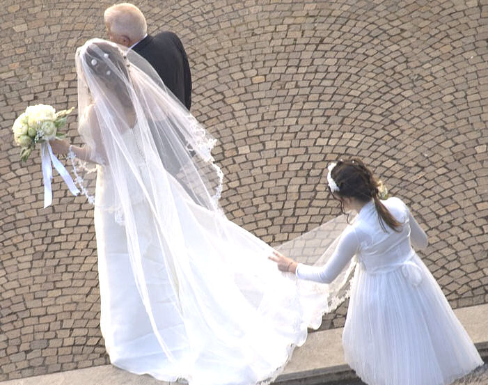 Bride and Father with bridesmaid holding
train