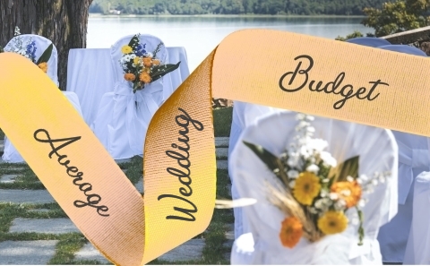 Apricot Ribbon reading
Average Wedding Budget over a background of white
covered chairs decorated with multicoloured
flowers with a river in the background