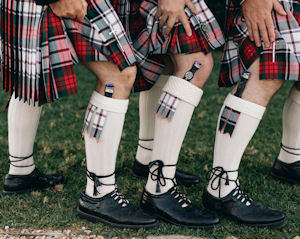 Groomsmen
displaying the sgian dubh in their hose.
Photo by Figtree Pictures