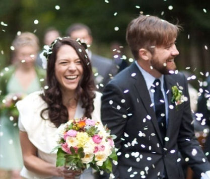 Paper Confetti being thrown over
bride and groom