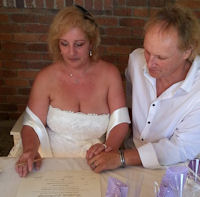 Laurence and Richard signing their marriage
certificate after their marriage by Jennifer Cram,
Brisbane Celebrant